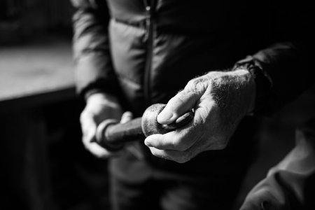 Greg Updike Holds an Object Found in Alaska Commercial Divers' Warehouse