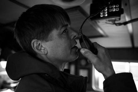 Craig Thomas Demonstrates Radio in the Cabin of the <i>F/V Dive Master</i>