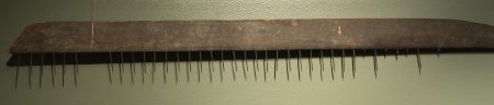 Detail of herring rake made of Douglas fir with brass tines.